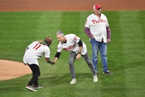 Nov 2, 2022; Philadelphia, Pennsylvania, USA; Former Philadelphia Phillies shortstop Jimmy Rollins shakes hands with former second baseman Chase Utley before they threw out the ceremonial first pitch with former manager Charlie Manuel looking on before game four of the 2022 World Series against the Houston Astros at Citizens Bank Park.