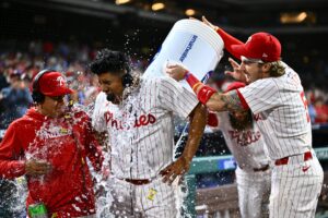 Apr 16, 2024; Philadelphia, Pennsylvania, USA; Philadelphia Phillies starting pitcher Ranger Suarez (55) is showered by second baseman Bryson Stott (5) and outfielder Brandon Marsh (16) after pitching a complete game shutout against the Colorado Rockies at Citizens Bank Park.