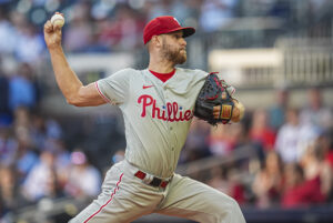 Aug 20, 2024; Cumberland, Georgia, USA; Philadelphia Phillies starting pitcher Zack Wheeler (45) pitches against the Atlanta Braves during the first inning at Truist Park.