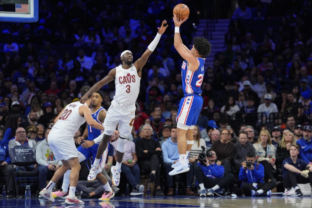 Nov 13, 2024; Philadelphia, Pennsylvania, USA; Philadelphia 76ers guard Jared McCain (20) shoots the ball against Cleveland Cavaliers guard Caris LeVert (3) in the third quarter at Wells Fargo Center.