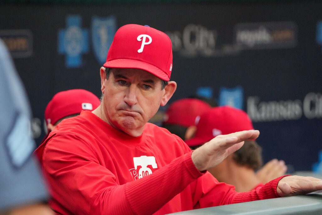 Aug 23, 2024; Kansas City, Missouri, USA; Philadelphia Phillies manager Rob Thomson (59) in the dugout against the Kansas City Royals prior to a game at Kauffman Stadium.