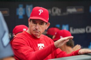 Aug 23, 2024; Kansas City, Missouri, USA; Philadelphia Phillies manager Rob Thomson (59) in the dugout against the Kansas City Royals prior to a game at Kauffman Stadium.
