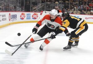 Feb 27, 2025; Pittsburgh, Pennsylvania, USA; Philadelphia Flyers defenseman Travis Sanheim (6) and Pittsburgh Penguins right wing Bryan Rust (17) chase the puck during the third period at PPG Paints Arena.