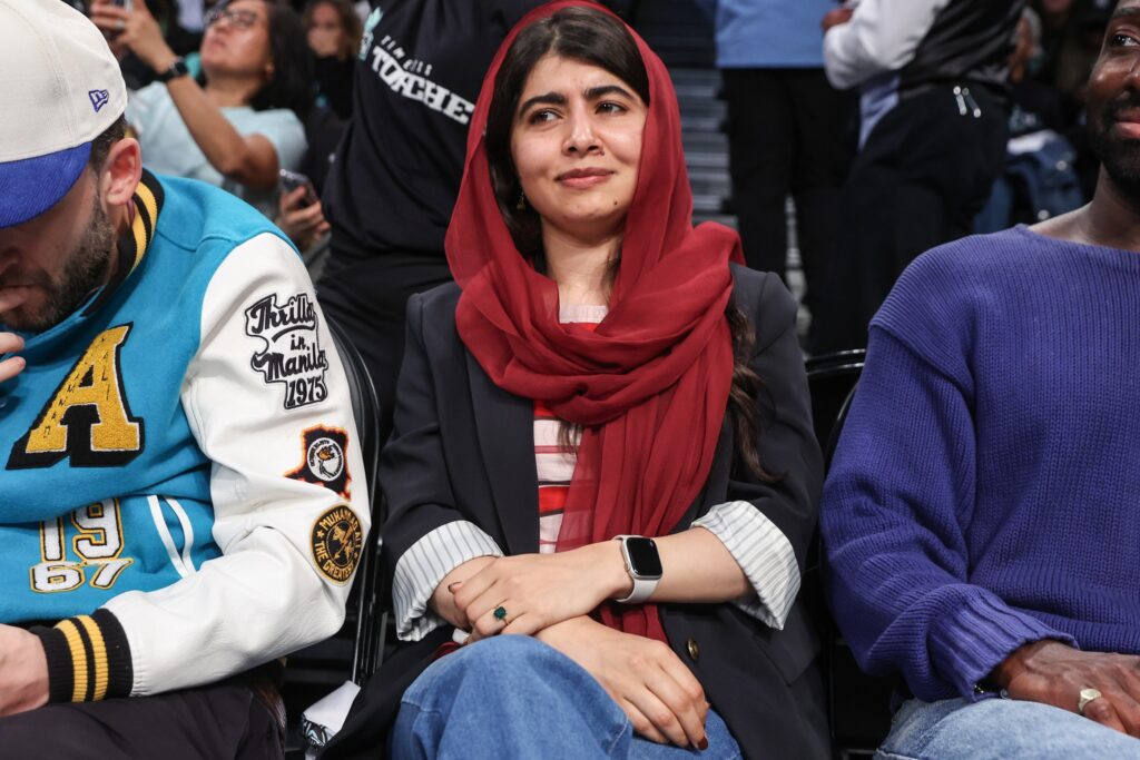 Sep 17, 2025; Brooklyn, New York, USA; Nobel Prize laureate Malala Yousafzai sits courtside during game two of round one for the 2025 WNBA Playoffs between the Phoenix Mercury and the New York Liberty at Barclays Center.