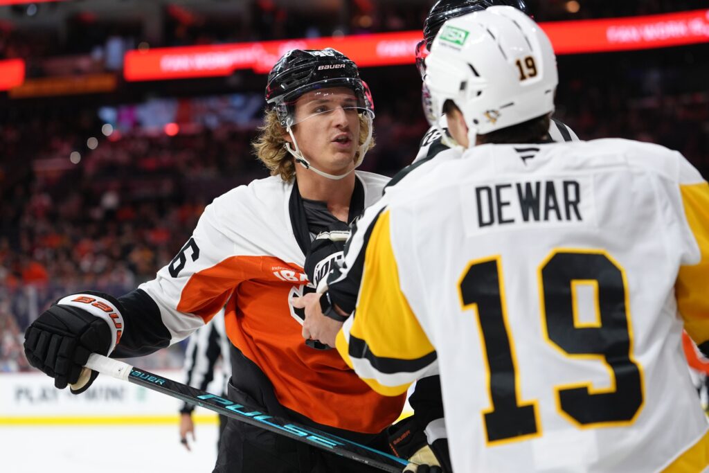Oct 28, 2025; Philadelphia, Pennsylvania, USA; Philadelphia Flyers center Trevor Zegras (46) reacts against Pittsburgh Penguins center Connor Dewar (19) in the third period at Xfinity Mobile Arena.
