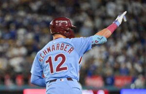 Oct 8, 2025; Los Angeles, California, USA; Philadelphia Phillies designated hitter Kyle Schwarber (12) celebrates after hitting a solo home run during the fourth inning against the Los Angeles Dodgers during game three of the NLDS round for the 2025 MLB playoffs at Dodger Stadium.