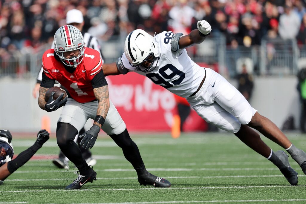 Nov 1, 2025; Columbus, Ohio, USA; Ohio State Buckeyes wide receiver Brandon Inniss (1) runs the ball as Penn State Nittany Lions defensive end Yvan Kemajou (99) makes the tackle during the third quarter at Ohio Stadium