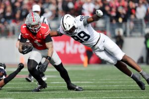 Nov 1, 2025; Columbus, Ohio, USA; Ohio State Buckeyes wide receiver Brandon Inniss (1) runs the ball as Penn State Nittany Lions defensive end Yvan Kemajou (99) makes the tackle during the third quarter at Ohio Stadium