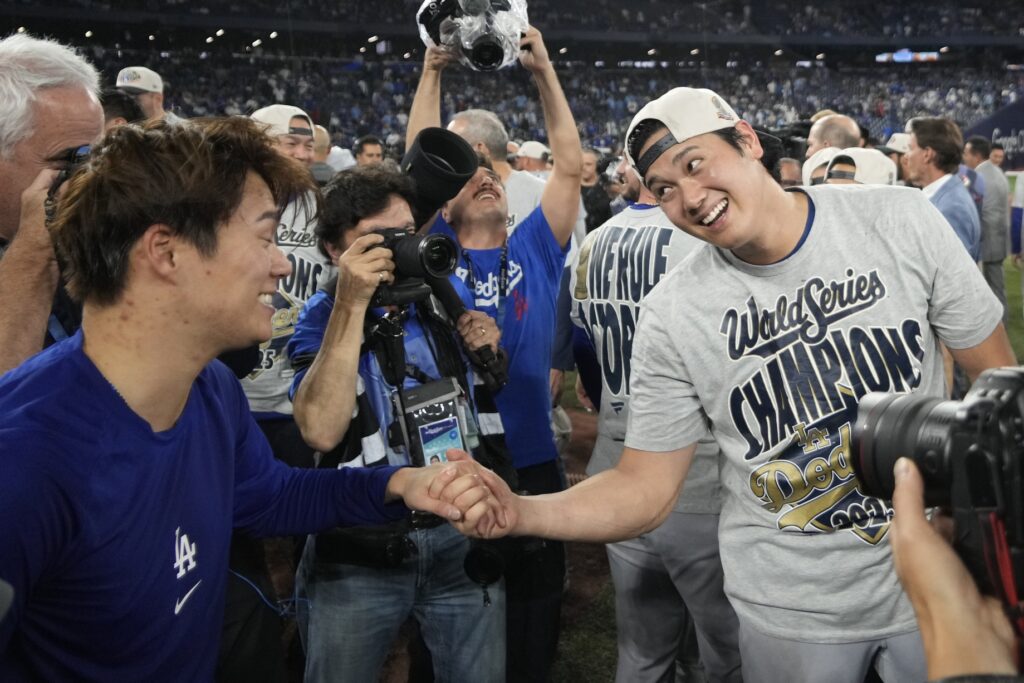 Nov 1, 2025; Toronto, Ontario, CAN; Los Angeles Dodgers two-way player Shohei Ohtani (17) celebrates with pitcher Yoshinobu Yamamoto (18) after defeating the Toronto Blue Jays during game seven of the 2025 MLB World Series at Rogers Centre.