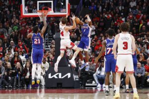 Nov 4, 2025; Chicago, Illinois, USA; Philadelphia 76ers guard Tyrese Maxey (0) defends against Chicago Bulls forward Matas Buzelis (14) during the second half at United Center.
