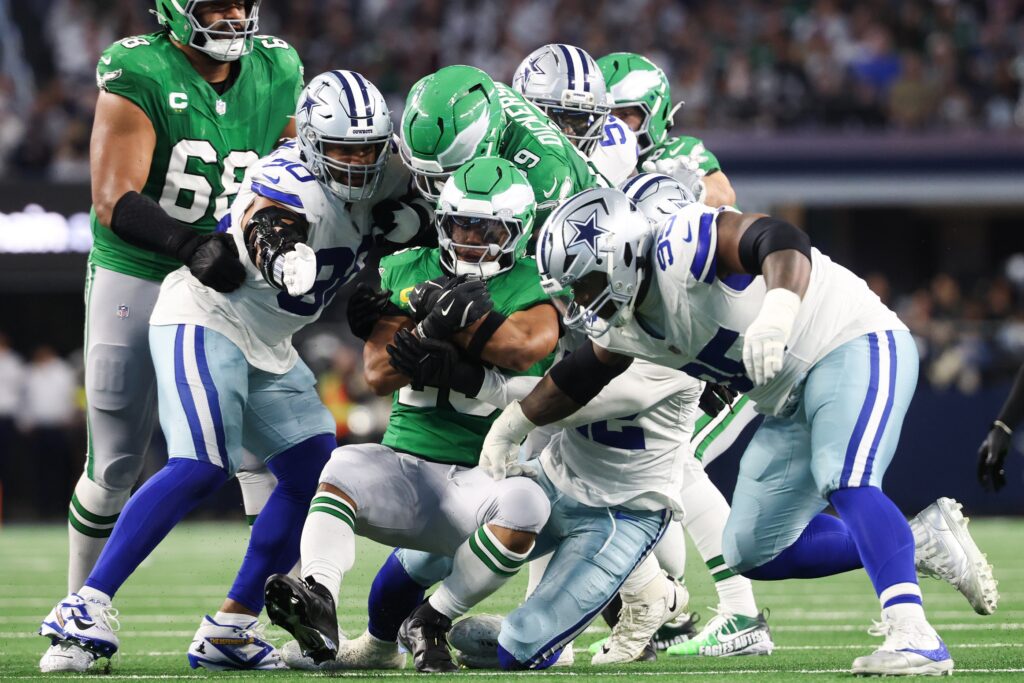 Nov 23, 2025; Arlington, Texas, USA; Philadelphia Eagles running back Saquon Barkley (26) is brought down in the second quarter against the Dallas Cowboys at AT&T Stadium.