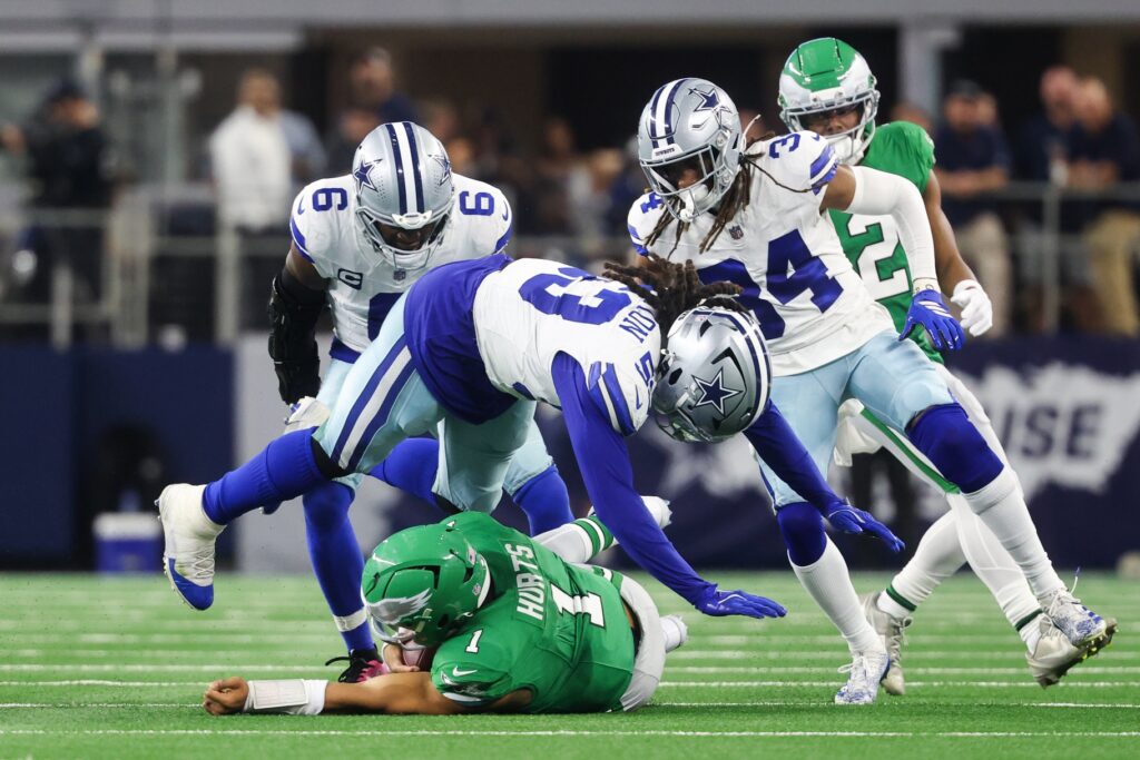 Nov 23, 2025; Arlington, Texas, USA; Philadelphia Eagles quarterback Jalen Hurts (1) slides with the ball in the third quarter against the Dallas Cowboys at AT&T Stadium.
