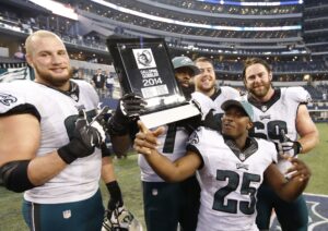 Nov 27, 2014; Arlington, TX, USA; Philadelphia Eagles running back LeSean McCoy (25) poses with the Galloping Gobbler award and tackle Lane Johnson (65) Jason Peters (71) guard Andrew Gardner (66) and Evan Mathis (69) after the game against the Dallas Cowboys at AT&T Stadium. The Eagles beat the Cowboys 33-10.