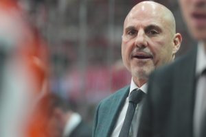 Oct 11, 2025; Raleigh, North Carolina, USA; Philadelphia Flyers head coach Rick Tocchet looks on from behind the players bench against the Carolina Hurricanes during the first period at Lenovo Center.