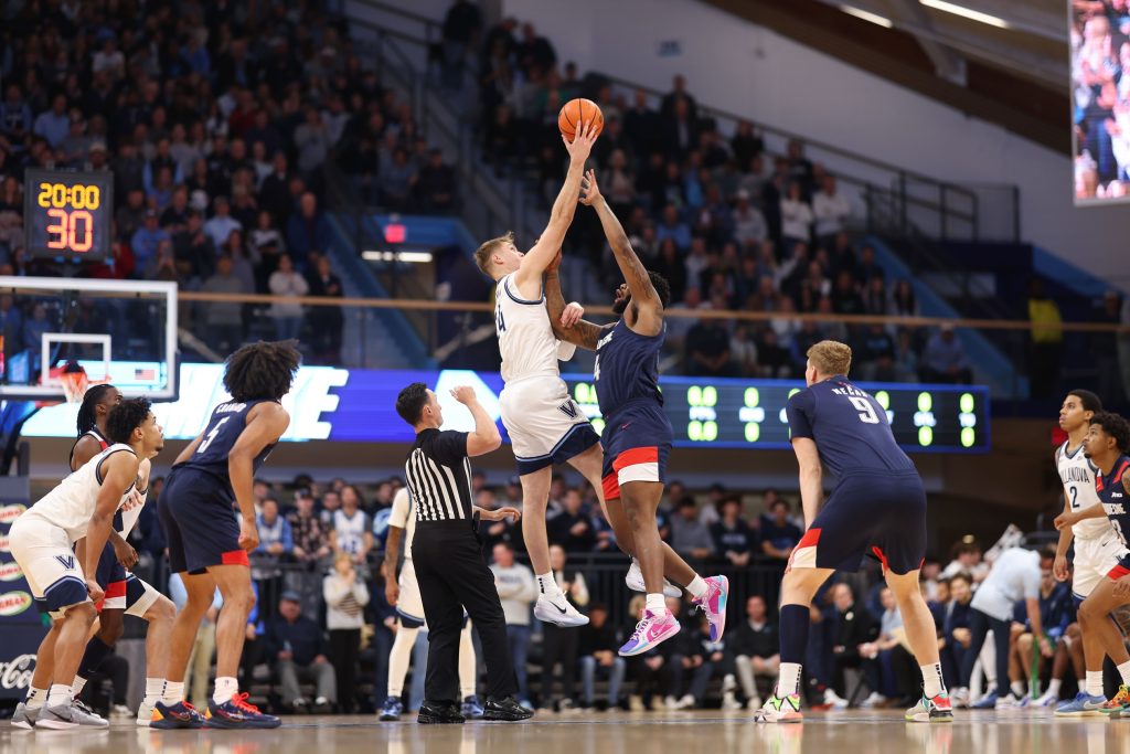 Nov 15, 2025; Villanova, Pennsylvania, USA; Villanova Wildcats forward Duke Brennan (24) and Duquesne Dukes forward John Hugley IV (4) tip off to start the first half at William B. Finneran Pavilion.
