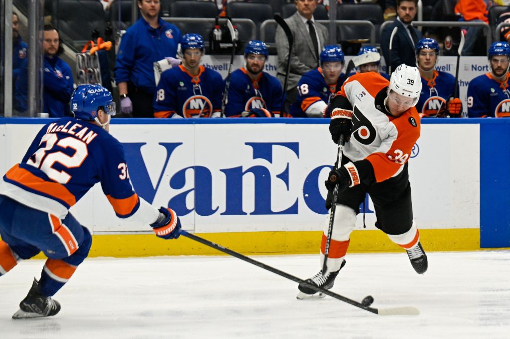 Nov 28, 2025; Elmont, New York, USA; New York Islanders center Kyle MacLean (32) blocks the shot by Philadelphia Flyers right wing Matvei Michkov (39) during the third period at UBS Arena.
