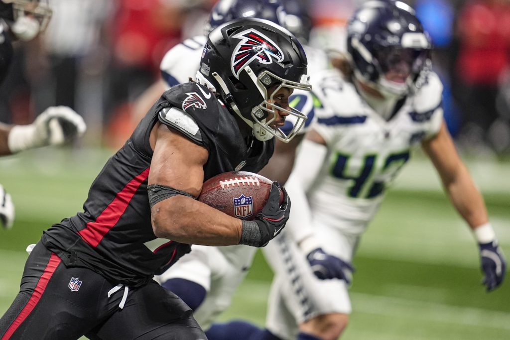 Dec 7, 2025; Atlanta, Georgia, USA; Atlanta Falcons running back Bijan Robinson (7) runs against the Seattle Seahawks during the first half at Mercedes-Benz Stadium.
