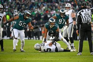 Dec 14, 2025; Philadelphia, Pennsylvania, USA; Las Vegas Raiders quarterback Kenny Pickett (15) is sacked by Philadelphia Eagles linebacker Nolan Smith Jr. (3) during the third quarter at Lincoln Financial Field.