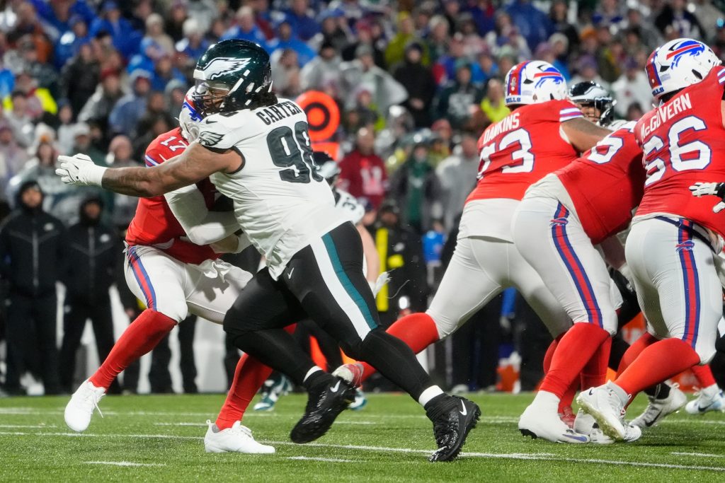 Dec 28, 2025; Orchard Park, New York, USA; Philadelphia Eagles defensive tackle Jalen Carter (98) sacks Buffalo Bills quarterback Josh Allen (17) during the second quarter at Highmark Stadium.