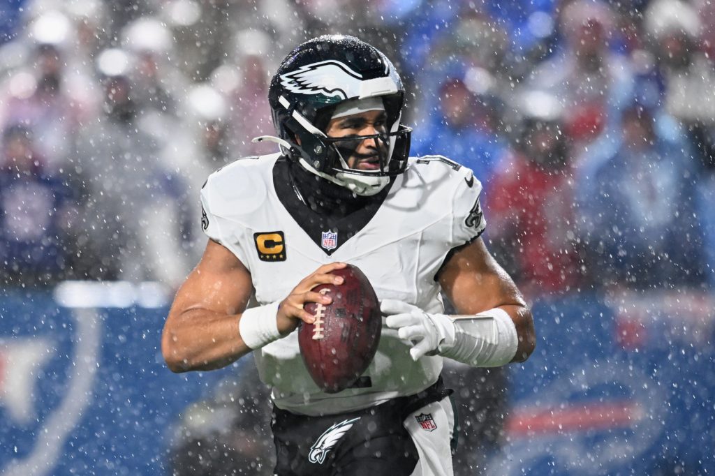 Dec 28, 2025; Orchard Park, New York, USA; Philadelphia Eagles quarterback Jalen Hurts (1) looks to throw a pass in heavy rain against the Buffalo Bills during the second quarter at Highmark Stadium.