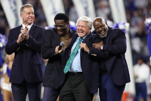 Dec 30, 2023; Arlington, Texas, USA; Dallas Cowboys former head coach Jimmy Johnson laughs with former players Troy Aikman and Michael Irvin and Emmitt Smith after being inducted into the ring of honor at halftime of the game against the Detroit Lions at AT&T Stadium.