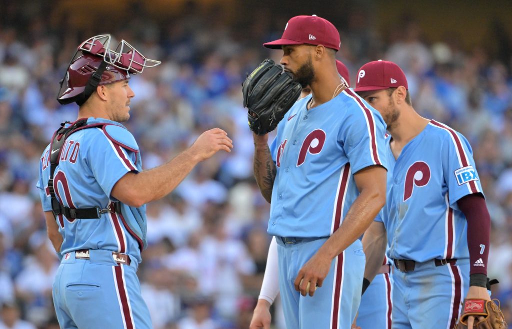 Oct 9, 2025; Los Angeles, California, USA; Philadelphia Phillies catcher J.T. Realmuto (10) talks to pitcher Cristopher Sanchez (61) in the sixth inning against the Los Angeles Dodgers during game four of the NLDS round for the 2025 MLB playoffs at Dodger Stadium.