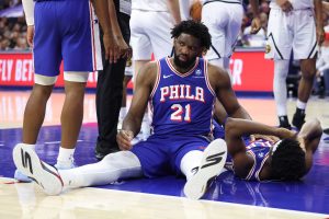 Jan 5, 2026; Philadelphia, Pennsylvania, USA; Philadelphia 76ers center Joel Embiid (21) looks on after falling to the court with guard Vj Edgecombe (77) during the fourth quarter against the Denver Nuggets at Xfinity Mobile Arena.