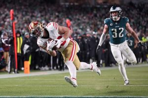 Jan 11, 2026; Philadelphia, PA, USA; San Francisco 49ers running back Christian McCaffrey (23) makes a catch for a touchdown defended by Philadelphia Eagles safety Reed Blankenship (32) during the fourth quarter in an NFC Wild Card Round game at Lincoln Financial Field.