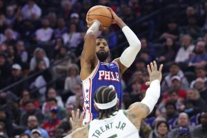 Jan 27, 2026; Philadelphia, Pennsylvania, USA; Philadelphia 76ers forward Paul George (8) shoots in front of Milwaukee Bucks guard Gary Trent Jr. (5) during the fourth quarter at Xfinity Mobile Arena.