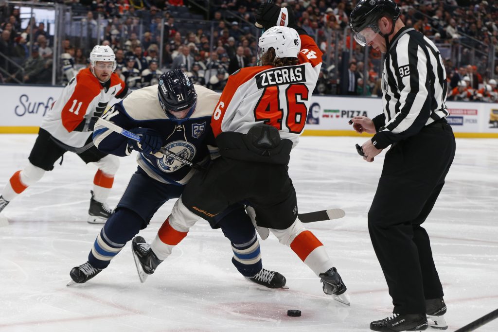 Jan 28, 2026; Columbus, Ohio, USA; Philadelphia Flyers center Trevor Zegras (46) and Columbus Blue Jackets center Isac Lundestrom (21) battle for the puck after a face-off during the third period at Nationwide Arena.