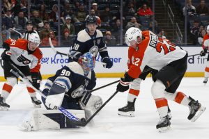 Jan 28, 2026; Columbus, Ohio, USA; Columbus Blue Jackets goalie Elvis Merzlikins (90) makes a save as Philadelphia Flyers center Christian Dvorak (22) looks for a rebound during the third period at Nationwide Arena.