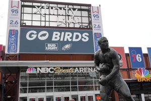 Feb 13, 2025; Philadelphia, PA, USA; A Philadelphia Eagles Bud Light advertisement and statue of boxer Joe Frazier at the NBC Sports Arena Philadelphia - Xfinity Live!