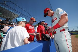 Mar 2, 2025; Dunedin, Florida, USA; Philadelphia Phillies infielder Aidan Miller (81) signs autographs for fans before a game against the Toronto Blue Jays during spring training at TD Ballpark.