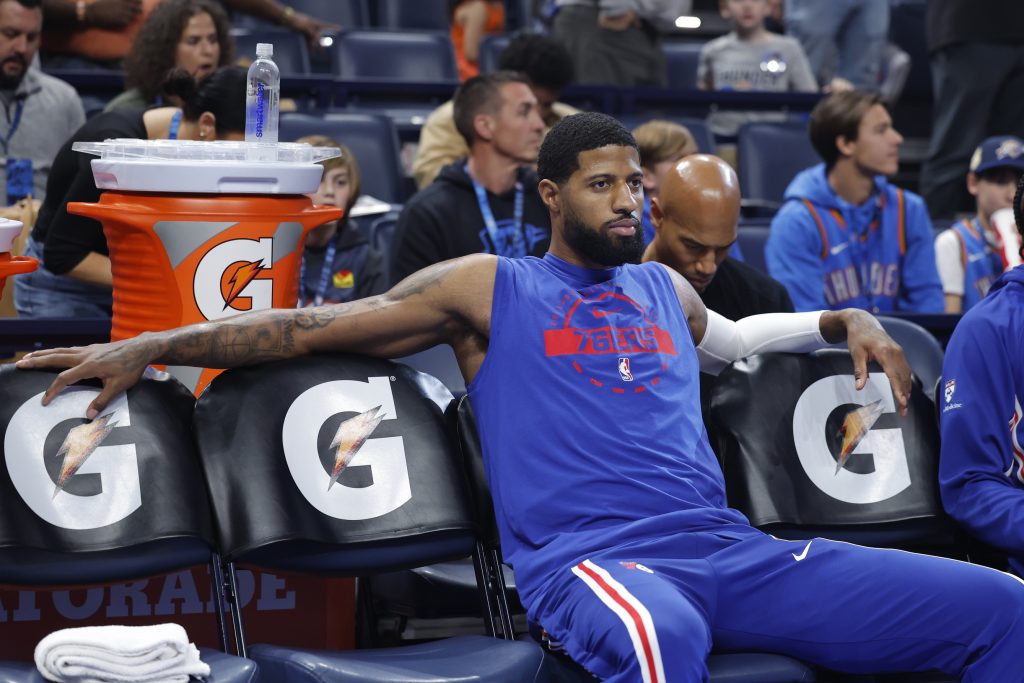 Dec 28, 2025; Oklahoma City, Oklahoma, USA; Philadelphia 76ers forward Paul George sits on the bench before the start of a game against the Oklahoma City Thunder at Paycom Center.