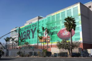 Jan 29, 2026; Santa Clara, California, USA; Workers erect a Super Bowl 60 advertisement for Uber Eats at the Hilton hotel.