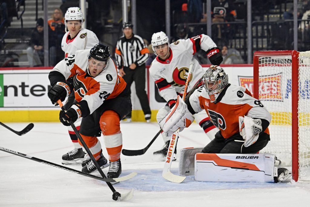 Feb 5, 2026; Philadelphia, Pennsylvania, USA; Philadelphia Flyers defenseman Nick Seeler (24) clears the puck in front of goaltender Dan Vladar (80) against the Ottawa Senators during the second period at Xfinity Mobile Arena.
