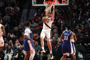 Feb 9, 2026; Portland, Oregon, USA; Portland Trail Blazers center Donovan Clingan (23) dunks the ball against the Philadelphia 76ers during the second half at Moda Center.