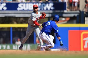 Feb 21, 2026; Dunedin, Florida, USA; Philadelphia Phillies infielder Edmundo Sosa (33) forces out Toronto Blue Jays outfielder RJ Schreck (9) and throws the ball to first base for a double play during the sixth inning at TD Ballpark.