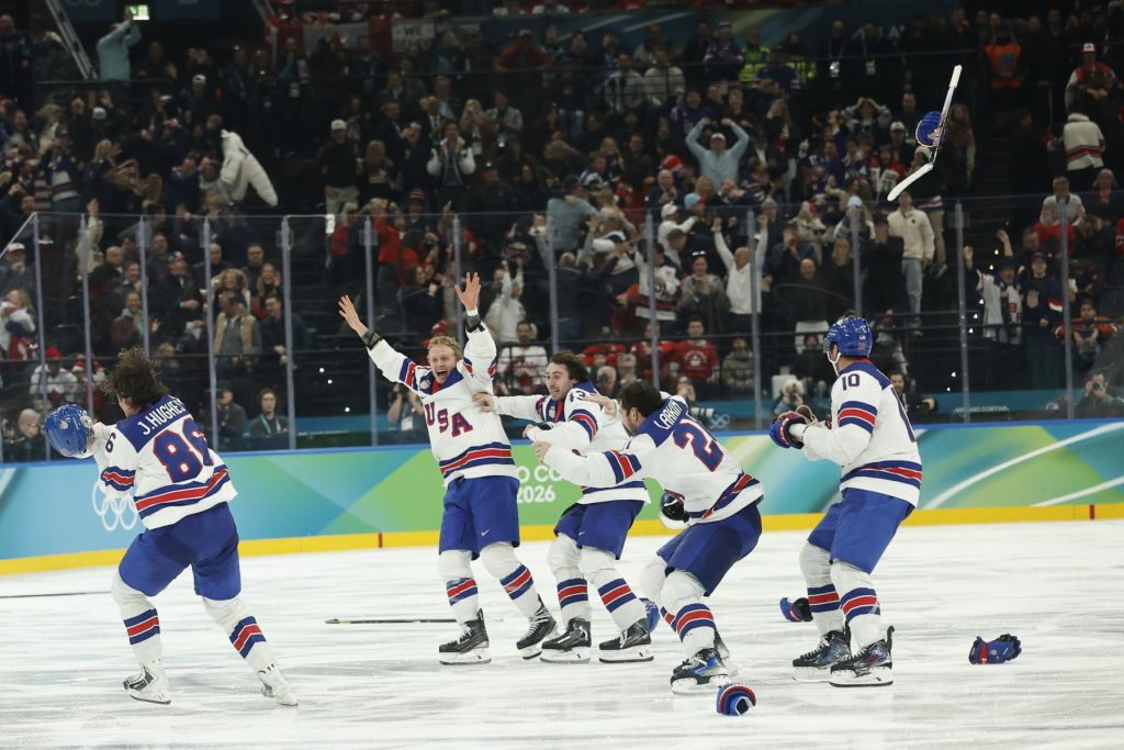 Feb 22, 2026; Milan, Italy; Jack Hughes #86 of Team United States celebrates with teammates after scoring the golden goal in overtime against Team Canada during the Milano Cortina 2026 Olympic Winter Games at Milano Santagiulia Ice Hockey Arena.