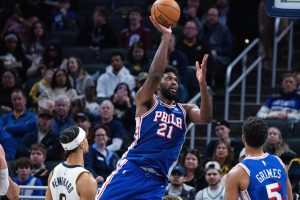 Feb 24, 2026; Indianapolis, Indiana, USA; Philadelphia 76ers center/forward Joel Embiid (21) shoots the ball while Indiana Pacers guard/forward Andrew Nembhard (2) defends in the first half at Gainbridge Fieldhouse.