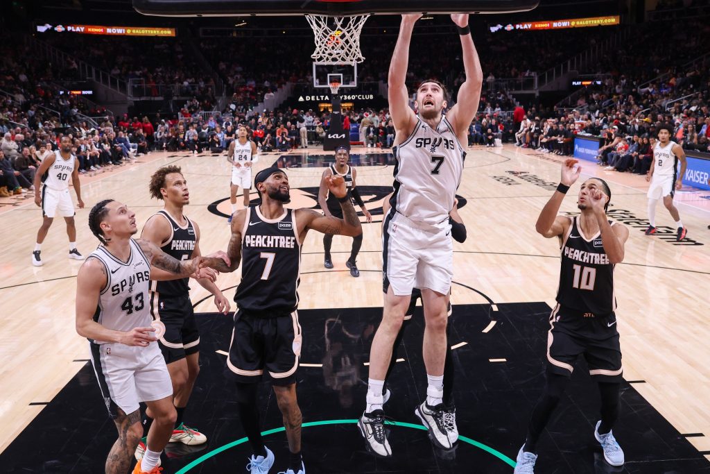 Dec 19, 2025; Atlanta, Georgia, USA; San Antonio Spurs center Luke Kornet (7) shoots against the Atlanta Hawks in the first half at State Farm Arena.