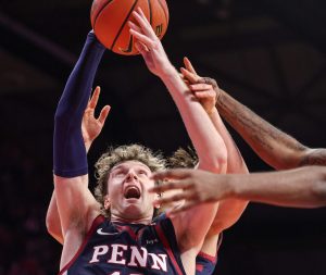Dec 20, 2025; Piscataway, New Jersey, USA; Penn Quakers forward TJ Power (12) rebounds during the second half against the Rutgers Scarlet Knights at Jersey Mike's Arena.