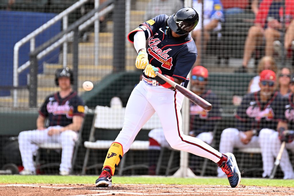 Feb 27, 2026; North Port, Florida, USA; Atlanta Braves designated hitter Jurickson Profar (17) hits a sacrifice fly to drive in a run in the first inning against the Boston Red Sox during spring training at CoolToday Park.