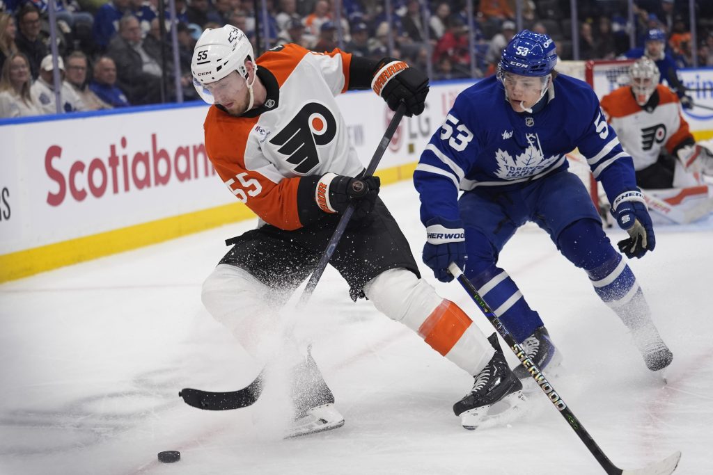 Mar 2, 2026; Toronto, Ontario, CAN; Philadelphia Flyers defenseman Rasmus Ristolainen (55) battles with Toronto Maple Leafs forward Easton Cowan (53) to get control of the puck during the third period at Scotiabank Arena.