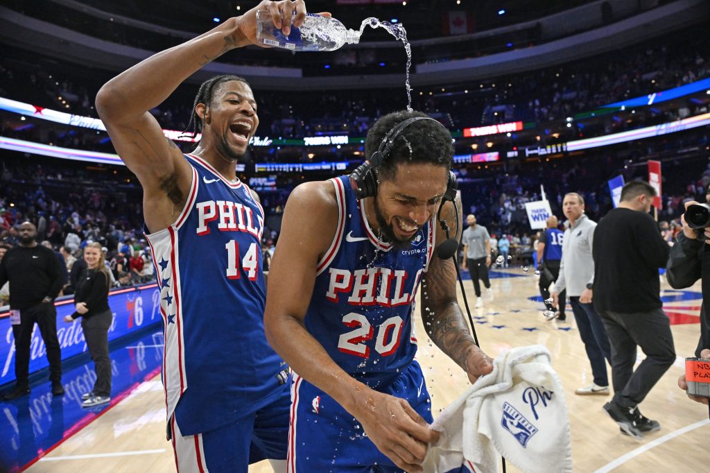 Mar 10, 2026; Philadelphia, Pennsylvania, USA; Philadelphia 76ers guard Cameron Payne (20) has water poured on him by forward Dalen Terry (14) after win against the Memphis Grizzlies at Xfinity Mobile Arena.