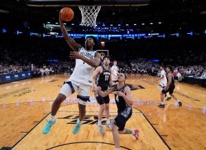Mar 12, 2026; New York, NY, USA; Villanova Wildcats guard Malachi Palmer (7) drives past Georgetown Hoyas forward Caleb Williams (4) during the first half at Madison Square Garden.