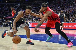 Mar 15, 2026; Philadelphia, Pennsylvania, USA; Philadelphia 76ers guard Quentin Grimes (5) is defended by Portland Trail Blazers forward Toumani Camara (33) during the second half at Xfinity Mobile Arena.
