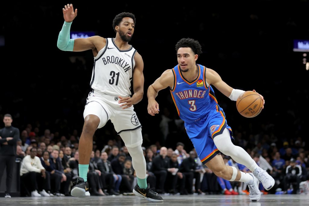 Mar 18, 2026; Brooklyn, New York, USA; Oklahoma City Thunder guard Jared McCain (3) drives to the basket against Brooklyn Nets forward Chaney Johnson (31) during the first quarter at Barclays Center.