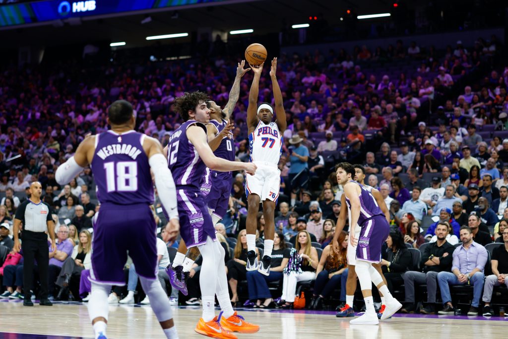 Mar 19, 2026; Sacramento, California, USA; Philadelphia 76ers guard Vj Edgecombe (77) scores against Sacramento Kings guard Malik Monk (0) during the second quarter at Golden 1 Center.