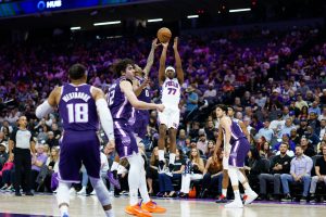 Mar 19, 2026; Sacramento, California, USA; Philadelphia 76ers guard Vj Edgecombe (77) scores against Sacramento Kings guard Malik Monk (0) during the second quarter at Golden 1 Center.